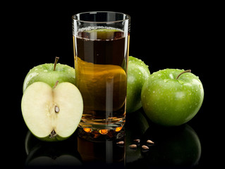 Three green apples and juice glass