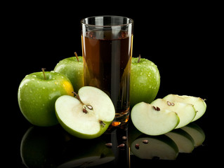 Three green apples and juice glass