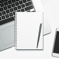 blank notepad and laptop
