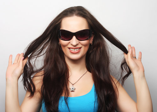 Young surprised woman wearing sunglasses.