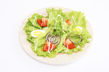 a fresh salad on a plate, look from above