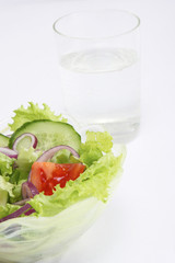 healthy food: a bowl with fresh salad, a glass of water on a