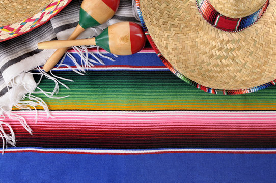 Mexican serape blanket background with sombrero and maracas for Mexico cinco de mayo festival fiesta photo