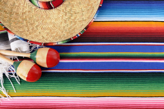 Mexican serape blanket background with sombrero and maracas for Mexico cinco de mayo festival fiesta photo