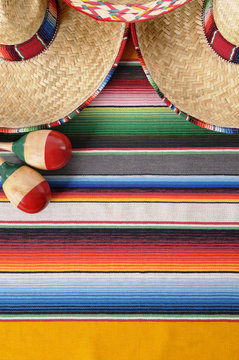 Mexican background with sombreros maracas and traditional serape blanket Mexico cinco de mayo fiesta