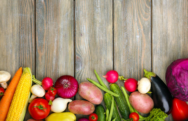 Summer frame with fresh organic vegetables on wooden background