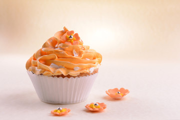 Delicious cupcake on beige background