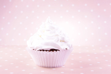 Delicious cupcake on beige background