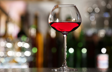 Glass of wine with bar on background