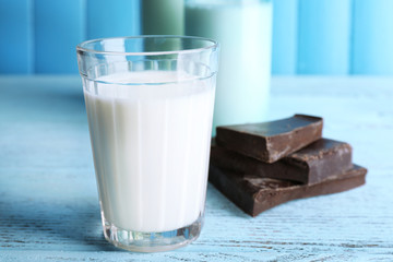 Glass and bottles of milk with chocolate chunks