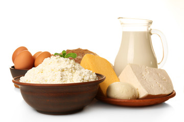 Dairy products in pottery,eggs and glass jug of milk isolated