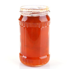 Homemade jar of apricot jam isolated on white background