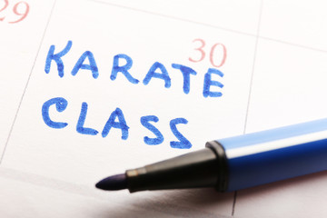 Written plan Karate Class on calendar page background