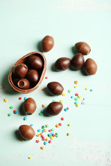Chocolate Easter Eggs on color wooden background