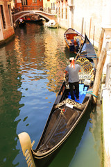 Fototapeta na wymiar Gondola with Gondolier in Venice, Italy