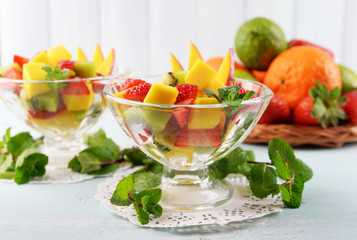 Fruit salad with mint in glassware