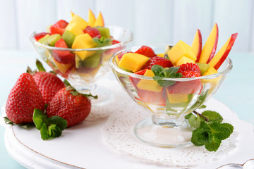 Fruit salad with mint in glassware