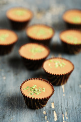 Tasty chocolate candies on wooden table
