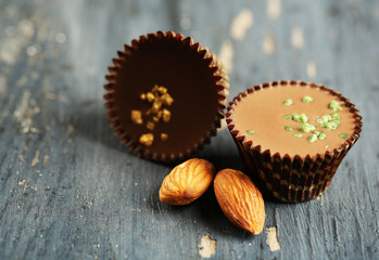 Obraz na płótnie Canvas Tasty chocolate candies with almond on wooden table
