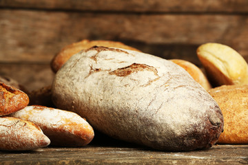 Different fresh bread on old wooden table