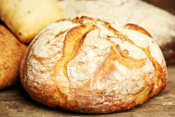 Different fresh bread on old wooden table