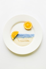 Fototapeta premium The concept of the beach and sea of oranges on a white round pla