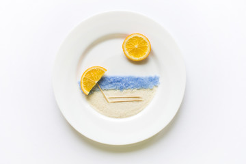 The concept of the beach and sea of oranges on a white round pla