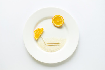 The concept of the beach of oranges on a white round plate