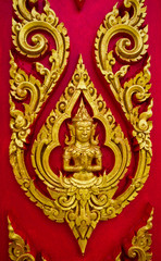 Thai painting carved on a church's door. In the Thai Buddhist te