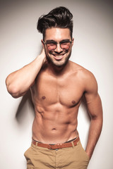 Happy young fashion man laughing to the camera