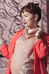 Beautiful young pregnant woman at spring sun outdoor