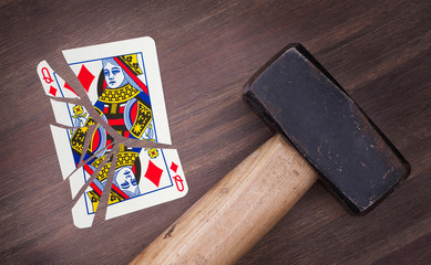 Hammer with a broken card, queen of diamonds