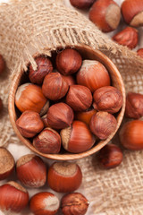 Hazelnut superfoods in wooden dish on vintage textile