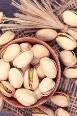 Pistachio super food mix in a wooden bowl with vintage toning