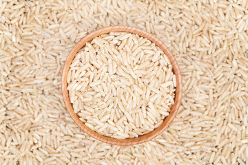 Raw brown rice superfood in a wooden bowl