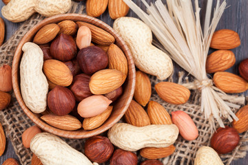 Super food different nuts mix on vintage textile background