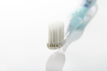 Fototapeta na wymiar turquoise toothbrush on white table