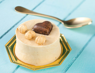 Small cake with hazelnuts and chocolate heart.