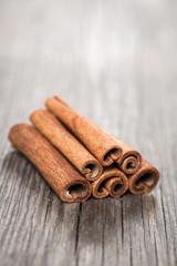 Cinnamon sticks on aged wooden background