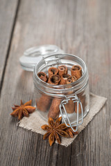 Cinnamon sticks in glass jar with anise stars