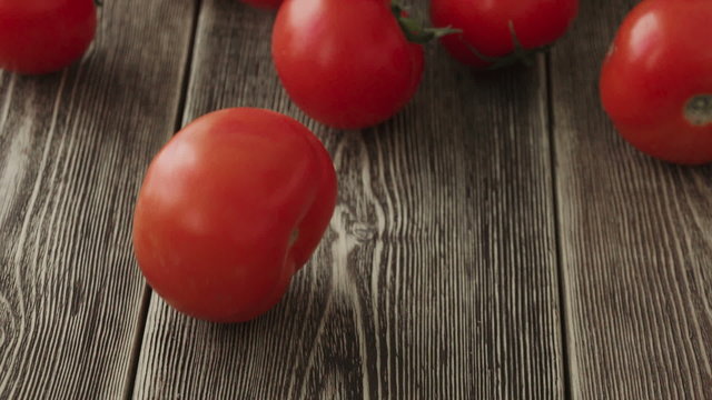 Tomatoes Roll Over The Screen In Slow Motion