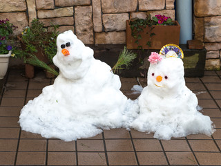 Two cute smiling snowman