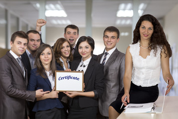 Female business trainer in front of the happy graduates