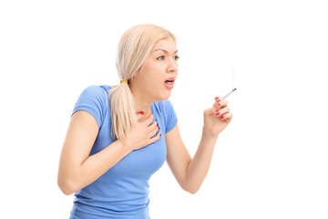 Young woman coughing from a cigarette