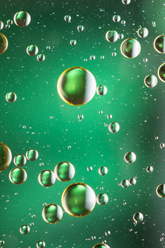 Oil and water abstract in green and gold