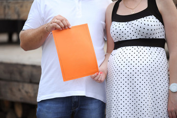Pregnant Wife and Husband with Paper