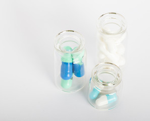 glass bottles with colorful pills