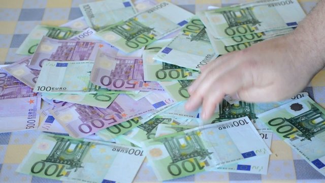 Money Sorted by Big Male Hands