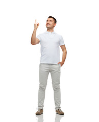 smiling man pointing finger up