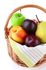 Assortment of juicy fruits in wicker basket, isolated on white